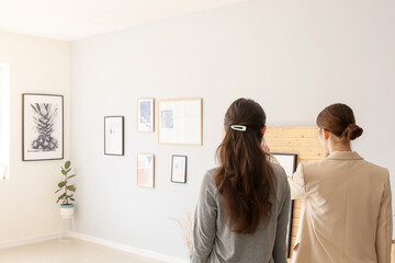 Women at exhibition in modern art gallery