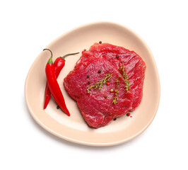 Plate with raw beef meat and spices on white background