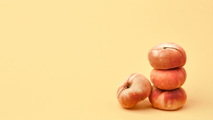 Composition with peaches. Ripe juicy peaches on a yellow background. A place to copy. Fresh organic fruits, vegan food. Background of Juicy Fruits
