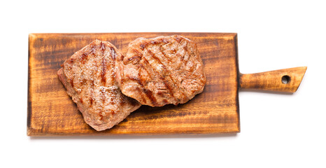 Wooden board with tasty beef steaks on white background