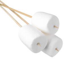 Sticks with delicious puffy marshmallows on white background