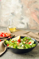 Plate of delicious fresh vegetable salad on grunge background