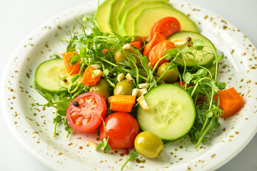 Plate of delicious salad with different vegetables and watercress, closeup