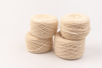 balls of light woolen thread on white background. natural wool. knitting. background
