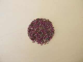 Dried pink heather flowers on a wooden board