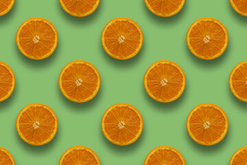Pattern of juicy and healthy oranges on pastel green background