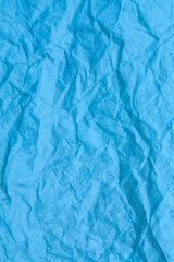 Blue crumpled paper background.