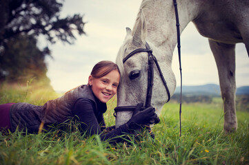 Girl with horse. Friendship between a girl and a horse. The girl is petting a horse.