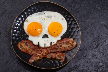 Fried eggs in the shape of a skull. Halloween healthy breakfast