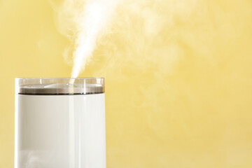 Modern humidifier on color background