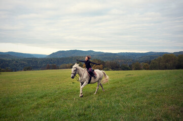 Girl with horse. The girl horseback riding in bautiful landscape. Girl in the saddle. The girl ride...