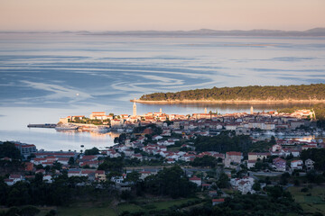 Early morning light on the old town of Rab and the island viewing form the hill of Kamenjak