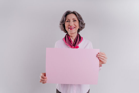 Happy Senior Woman Holding Pink Empty Paper