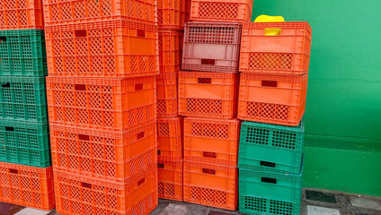 Multicolored plastic crates on the sidewalk