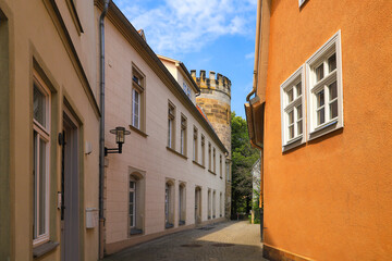 Fototapeta na wymiar A narrow alley with tower of the former city wall Coburg - Germany