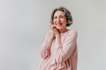 Happy stylish mature woman on light grey background