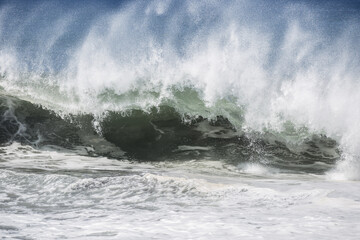 Big waves crashing, carrying mud, tsunami themed.