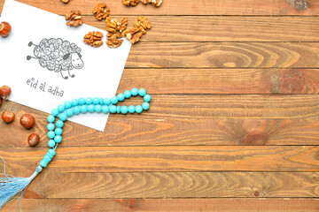 Greeting card for Eid al-Adha (Feast of the Sacrifice) with nuts and tasbih on wooden background