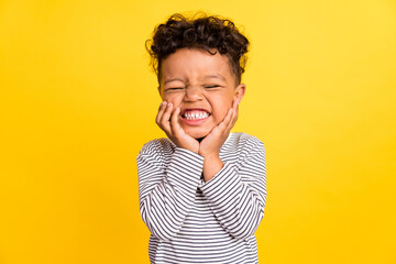 Photo portrait small boy laughing overjoyed touching face smiling isolated vivid yellow color background © deagreez