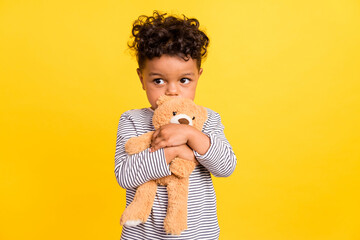 Photo portrait small boy cute embracing soft teddy bear isolated vibrant yellow color background