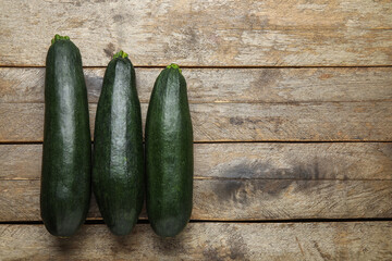 Fresh zucchini squashes on wooden background
