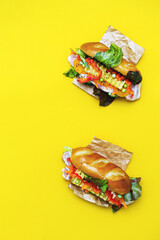 Banh mi vietnamese sandwiches with various stuffing, traditional breakfast. Flat lay on the yellow background, copy space.