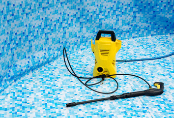 the pressure washer is in the pool. The pressure washer is used to wash the swimming pool