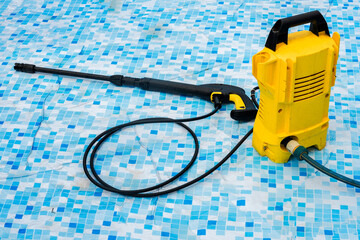 the pressure washer is in the pool. The pressure washer is used to wash the swimming pool