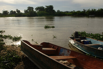 Naklejka na ściany i meble lake landscape with mangroves and fishermen's wooden boats at dusk