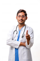 Doctor in a white coat with a stethoscope and showing thumbs up