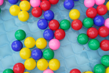 Color balls in swimming pool with water flat lay. High quality photo
