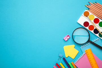 School supplies on blue background with copy space. Back to school concept.