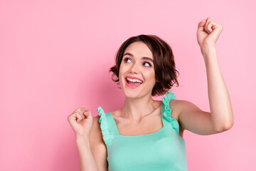 Portrait of attractive cheerful lucky girl dancing rejoicing having fun isolated over pink pastel color background