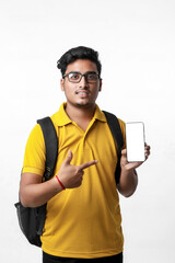 Fototapeta premium Young indian college student showing Mobile phone on white background.
