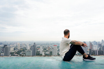 Fototapeta na wymiar Man practicing yoga on the rooftop