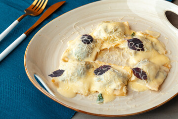 Italian dish ravioli with parmesan in a plate