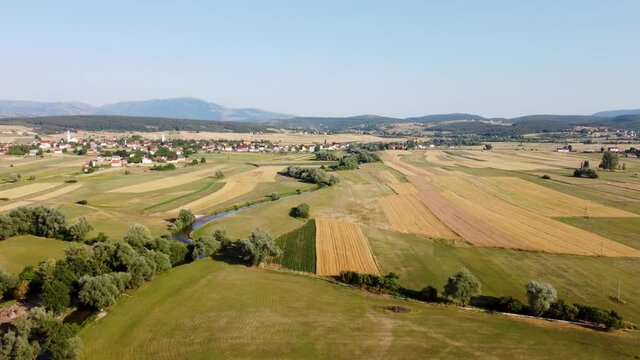 Arial drone view of field at summer. Field, villages and river.