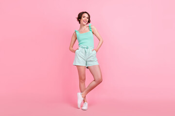 Full body photo of funky short hairdo young lady stand wear teal top shorts isolated on pink color background