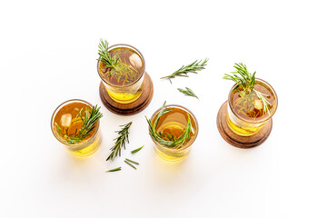Fefreshing drink of cold tea and rosemary herbs in glasses