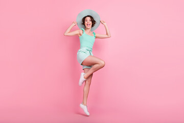 Fototapeta na wymiar Full length photo of cute short hairdo young lady jump wear teal top shorts hat isolated on pink color background
