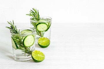 Cold fresh cocktail with lemon slices cucumber and rosemary