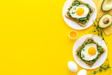 Eggs and avocado with spinach on toasted bread. Top view