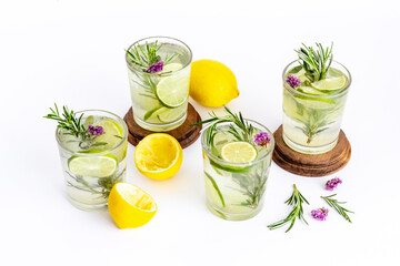 Fresh cold beverage with summer herbs and lemon in glasses