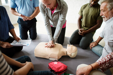 Group of diverse people in cpr training class - obrazy, fototapety, plakaty
