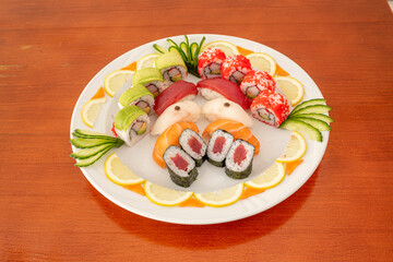Assorted sushi tray with bluefin tuna maki, surimi uramaki with avocado, salmon nigiri, bluefin tuna and butterfish and uramaki california roll