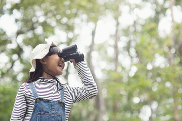 Happy kid looking ahead. Smiling child with the binoculars. Travel and adventure concept. Freedom,...
