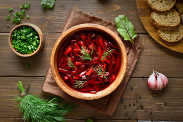 Borscht in bowl on wooden background