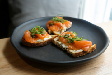 Healthy bruschetta with salmon and cream cheese	