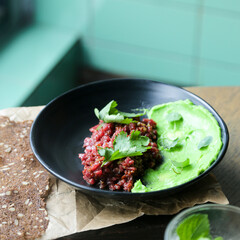 Traditional steak tartare with green hummus