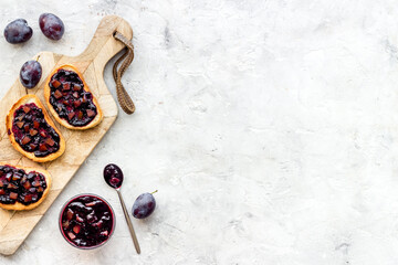 Toasted bread with plump jam. Food layout top view